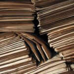 Stacks of aged brown paper envelopes stacked tightly, highlighting the storage of vintage archives.