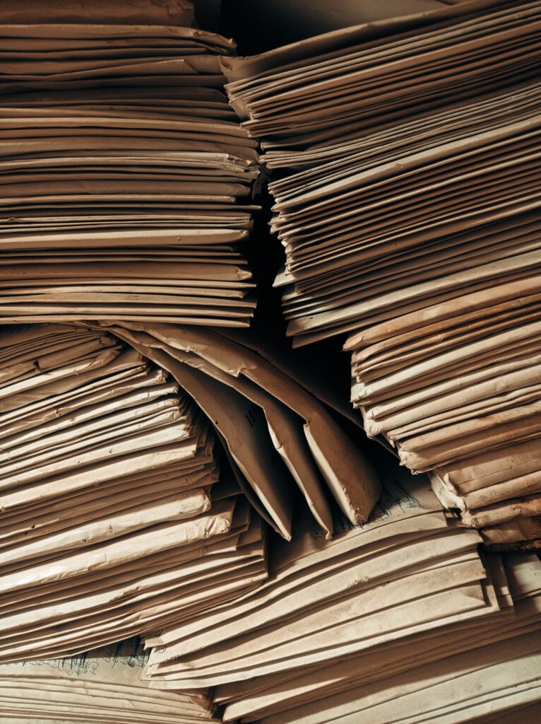 Stacks of aged brown paper envelopes stacked tightly, highlighting the storage of vintage archives.